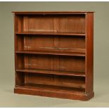 An Edwardian oak open bookcase, with moulded edge and adjustable shelves and with plinth base.