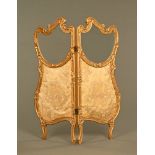 A late Victorian continental style gilt painted twofold glass and fabric screen.