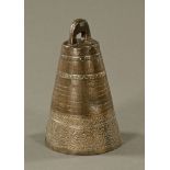 A bronze Tibetan bell, relief moulded. Height 25 cm.