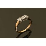 An 18 ct gold three stone diamond ring, yellow gold. Size L/M, 2.8 grams.