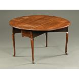 An 18th century mahogany pad foot dining table, twin drop flap and raised on cabriole legs.