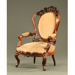 A Victorian walnut open armchair,