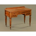 An early 19th century Georgian Gillows style writing table with reeded legs.