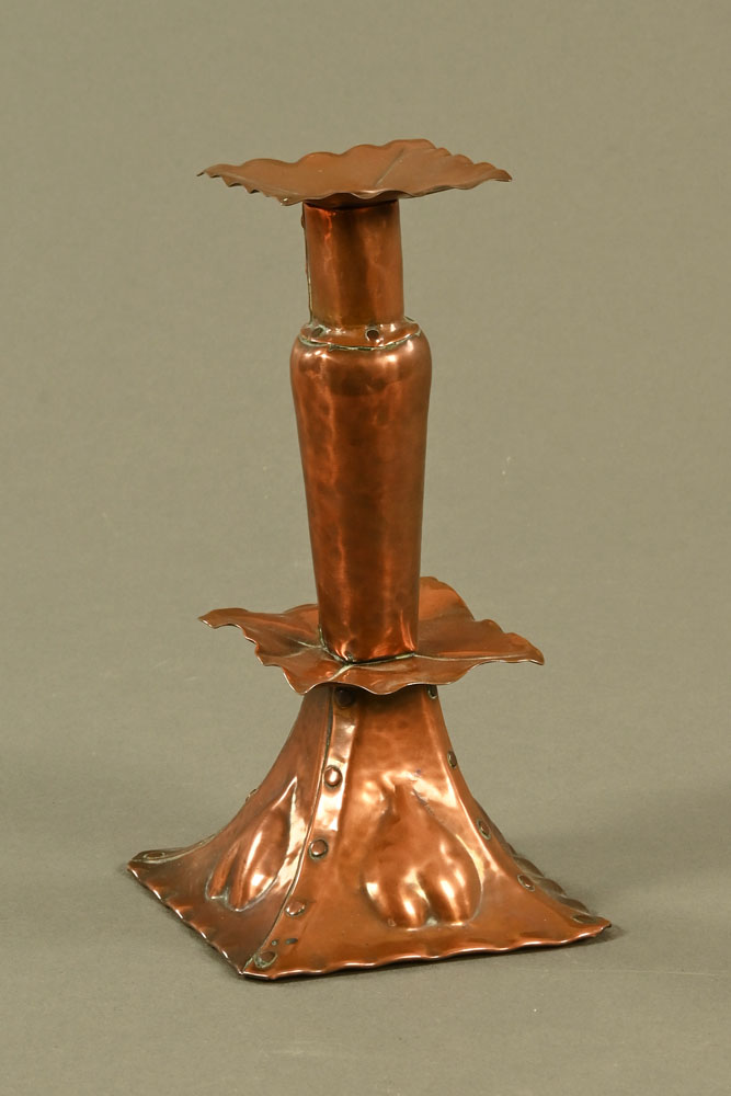 An Arts and Crafts copper candlestick, in the Keswick style with detachable sconce. Height 21 cm.