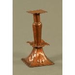 An Arts and Crafts copper candlestick, in the Keswick style with detachable sconce. Height 21 cm.