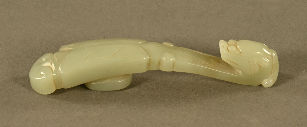 A Chinese carved jade button or belt hook in the form of a Chilong with folded wings. Length 11 cm. - Image 2 of 2