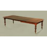 A Victorian mahogany extending dining table with three leaves,