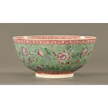 A large Chinese polychrome bowl, decorated with foliate scrolls,