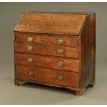 A George III oak and mahogany crossbanded bureau,