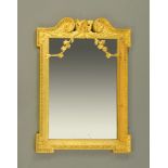 An 18th century or later carved giltwood mirror, in the manner of William Kent.