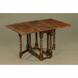 A 17th century oak gate leg table with bobbin turned legs. Height 74.