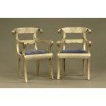 A pair of Regency style metal bound armchairs, with upholstered seats and raised on sabre legs.