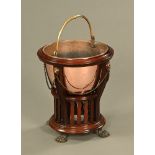 A late Victorian mahogany jardiniere stand with copper liner with handle and with metal mounts and