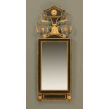 A Regency pier glass, ebonised and parcel gilt. Height 127 cm, width 47 cm (see illustration).