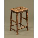 A Georgian style oak stool, with pierced handle to seat. Height 60 cm, width 38 cm, depth 29 cm.