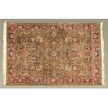 A Persian design carpet, with fringed ends, principal colours green, light blue,