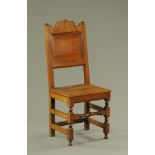 A late 17th century panelled back oak side chair.