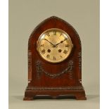 An Edwardian mahogany mitre topped mantle clock, with two train striking movement.