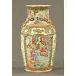 A 19th century Cantonese vase, with serpent handles and decorated in typical Canton colours.