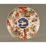 A large Japanese charger, decorated with dogs, cranes and chrysanthemum. Diameter 40 cm.