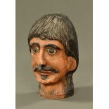 A carved wooden and painted head, male figure with moustache. Height 28 cm.