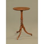 A Georgian mahogany tripod wine table, with reeded sabre legs. Height 74.5 cm, width 43 cm.