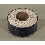 A circular silver topped pin cushion, and sewing box in leather. Diameter 17 cm.