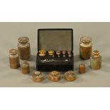 A cased set of gram weights, together with a collection of other brass weights.