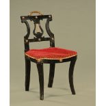 A Regency ebonised lyre back sabre legged side chair, with ormolu handle, from a music room.