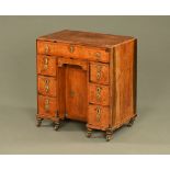 A rare early 18th century burr walnut kneehole desk, of unusually small proportions.