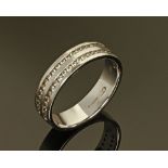 An 18 ct white gold diamond set half eternity ring, stamped 750. Size N, 3.8 grams.