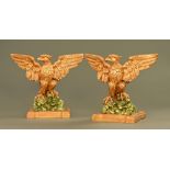 A large pair of Georgian William Kent style carved eagles, later painted.