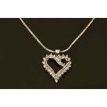 An 18 ct white gold heart shaped diamond set pendant on chain.