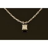 An 18 ct white gold pendant on chain, set with a princess cut diamond.