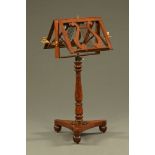 A Regency mahogany duet stand, with turned column and triform base raised on bun feet.