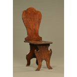 An 18th century Georgian mahogany hall chair of unusual scabello form.