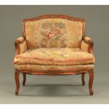 A late 19th century French beechwood fauteuil, upholstered in foliate tapestry material.