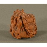 A Japanese intricately carved boxwood Netsuke of a Dog of Fo, bearing signature. Height 35 mm.