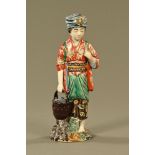 A Chinese Republic figure, holding a basket of oysters. Height 32 cm.