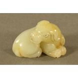 A Chinese green jade carving of a puppy. Length 5 cm.