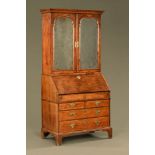 An early 18th century walnut bureau bookcase,