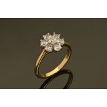 An 18 ct yellow gold diamond set daisy cluster ring, the shank inscribed 1 carat. Size M/N, 3.