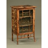 A late 19th century bamboo and lacquered cabinet,