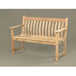 A teak garden bench, with slatted back and seat, raised on legs of square section. Width 126 cm.