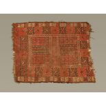 An Eastern fringed rug, with centre rectangular panel with book form motif and multiple line border,