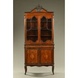 An Edwardian inlaid mahogany display cabinet, with swans neck pediment and glazed upper doors,