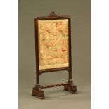 A 19th century tapestry fire screen, with rise and fall action. Height 102 cm, width 49 cm.