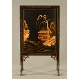 A chinoiserie black lacquered fire screen, circa 1930. Height 76 cm, width 43.5 cm.