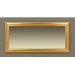 A large gilt framed mirror, rectangular with bevelled glass. External dimensions 170 cm x 81 cm.