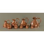 A graduated set of copper measures, from 2 gallons to 1/2 gill. Tallest 32 cm.